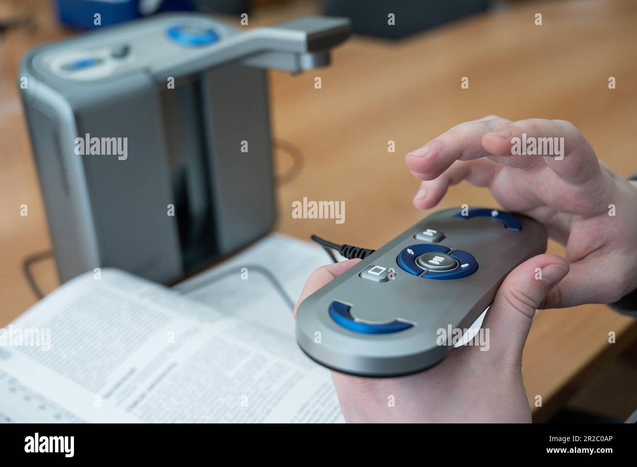 A visually impaired man uses a scanning and reading machine Stock Photo