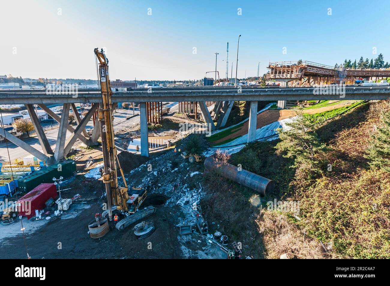 A drilling rig for drilled shafts to support a highway ramp as seen ...