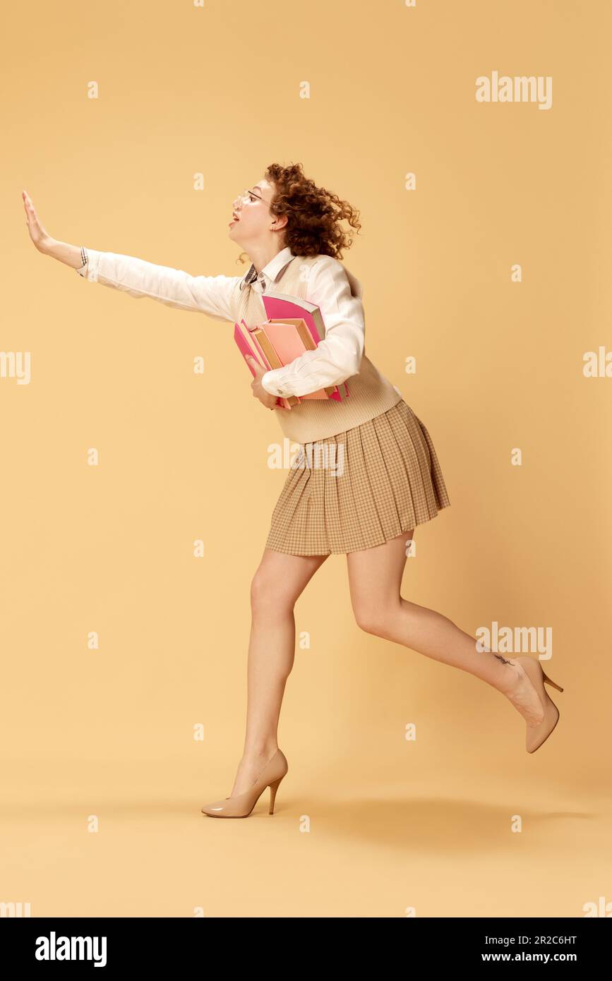 Being late for lesson, exam. Young pretty girl, student running on