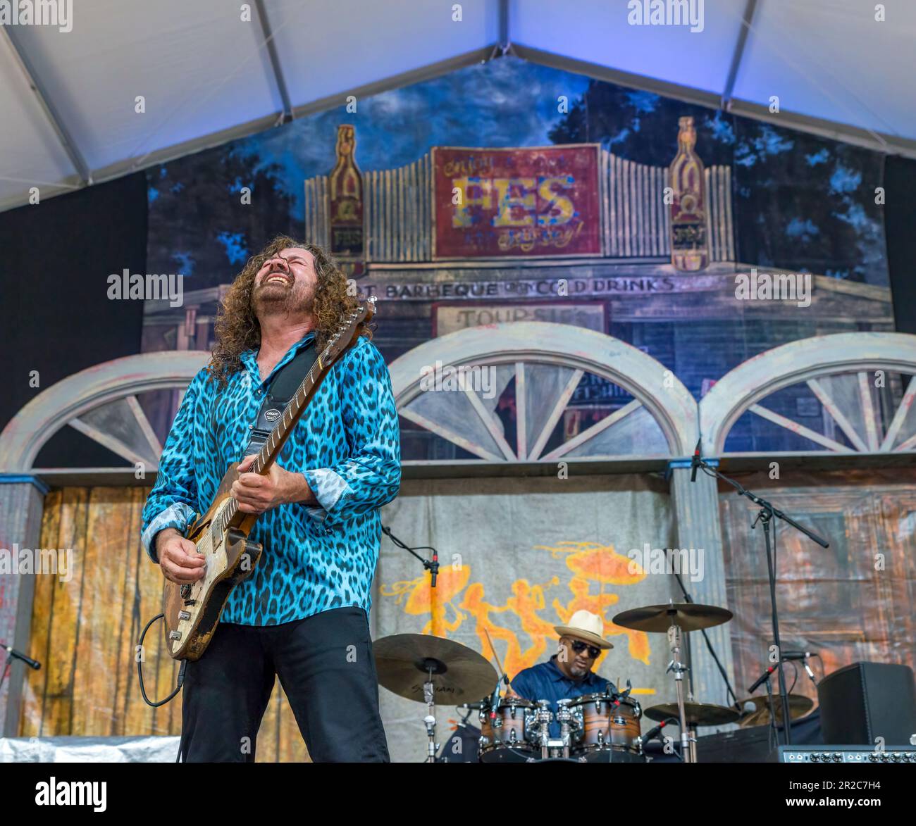 NEW ORLEANS, LA, USA - MAY 7, 2023: Tab Benoit plays the blues with his drummer in the background at the New Orleans Jazz and Heritage Festival Stock Photo