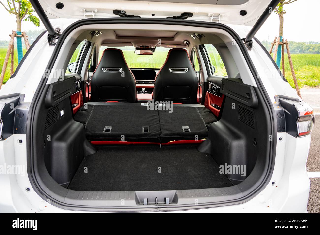 The trunk (boot) space of a Chery Tiggo 7 Pro (badged at Tiggo 7 Plus for China) SUV car with the rear seats folded down pictured during a test in Sha Stock Photo