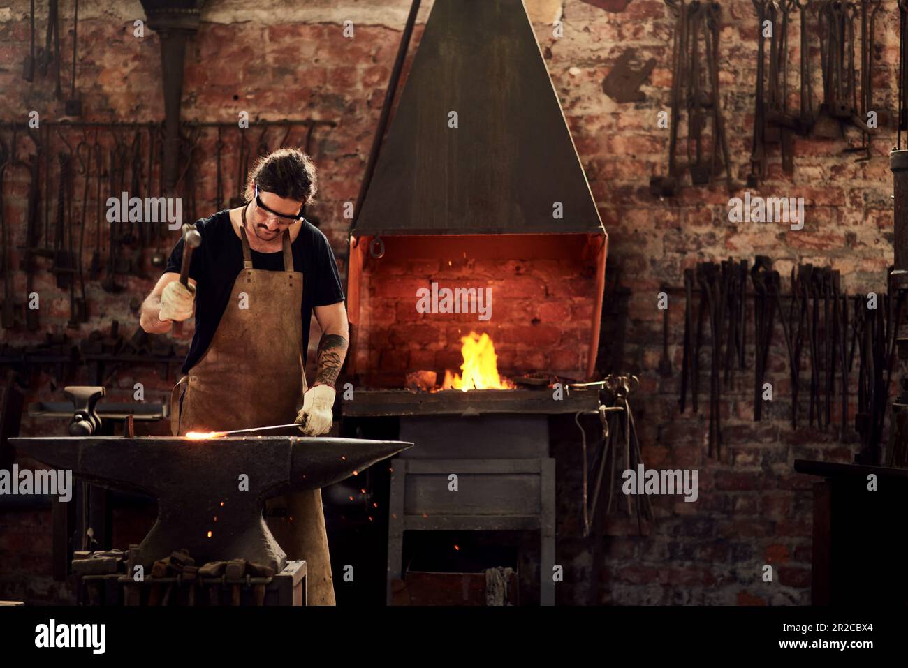 Blacksmith, and man in metal and manual working on hot