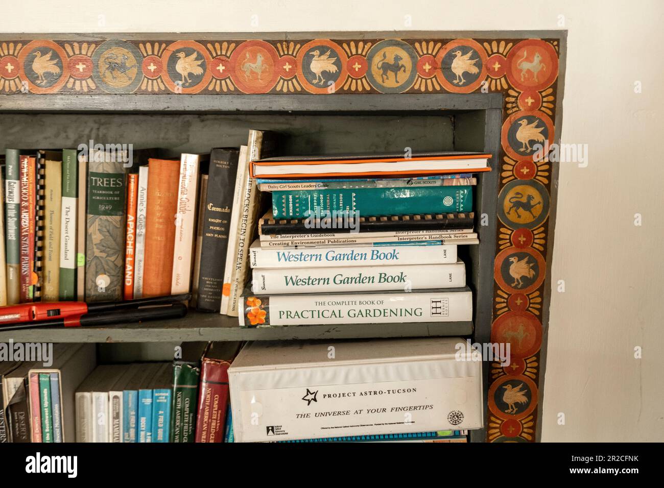 Painted bookshelf at the 1920s-era Kannally Ranch House, Oracle, Arizona, USA Stock Photo