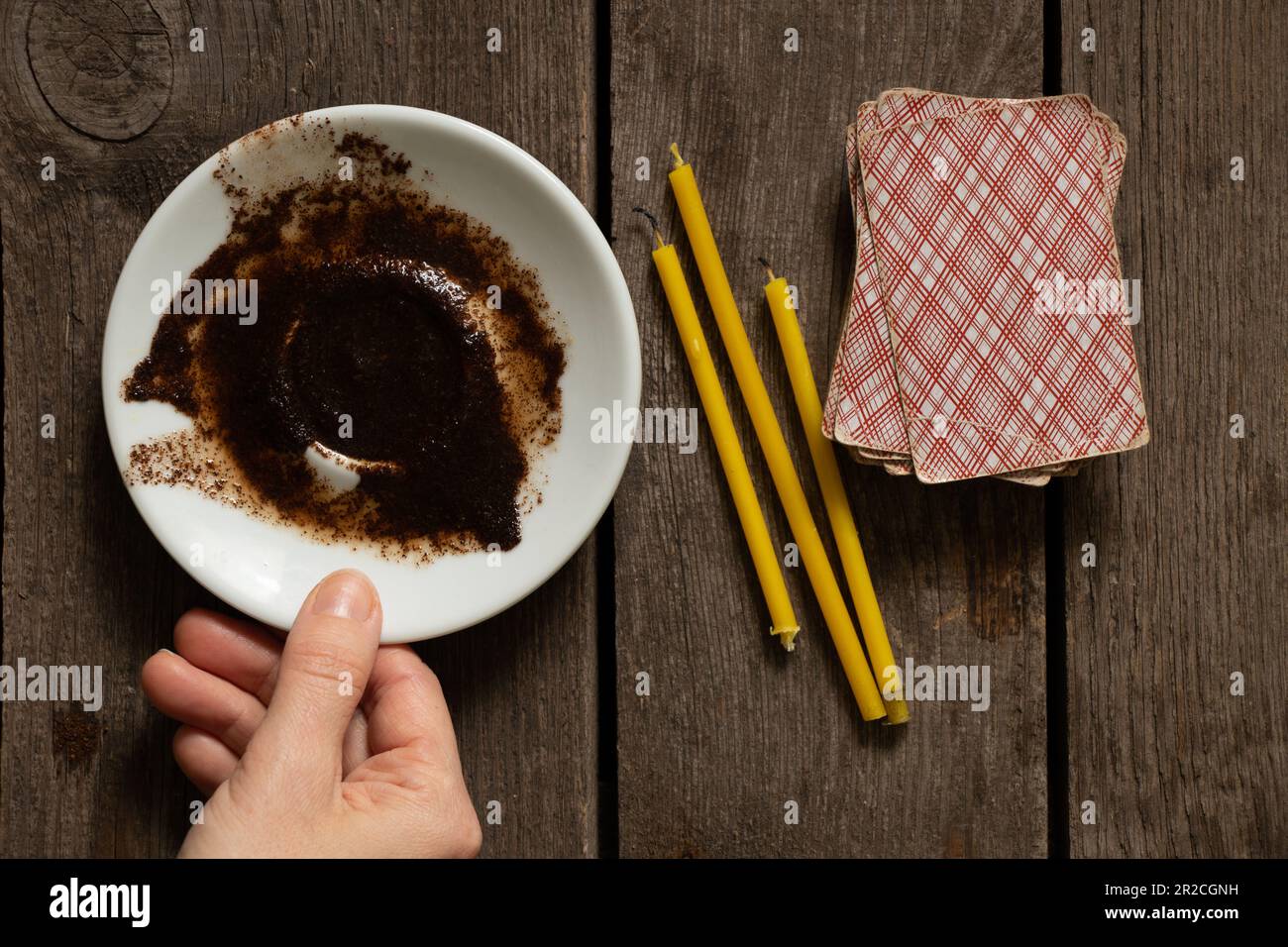 coffee grounds on a saucer for fortune telling cards and candles on the table, fortune telling