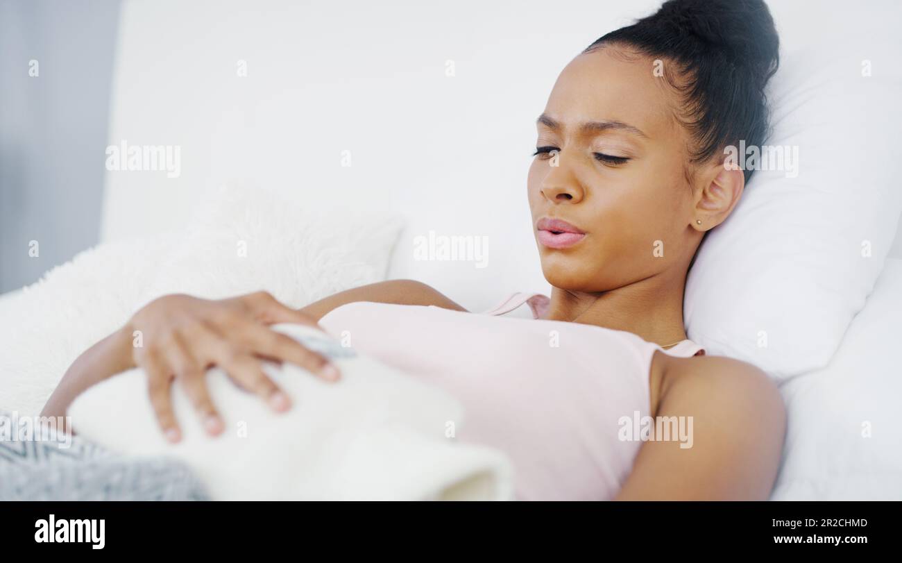 Woman, stomach ache and period cramps, hot water bottle for