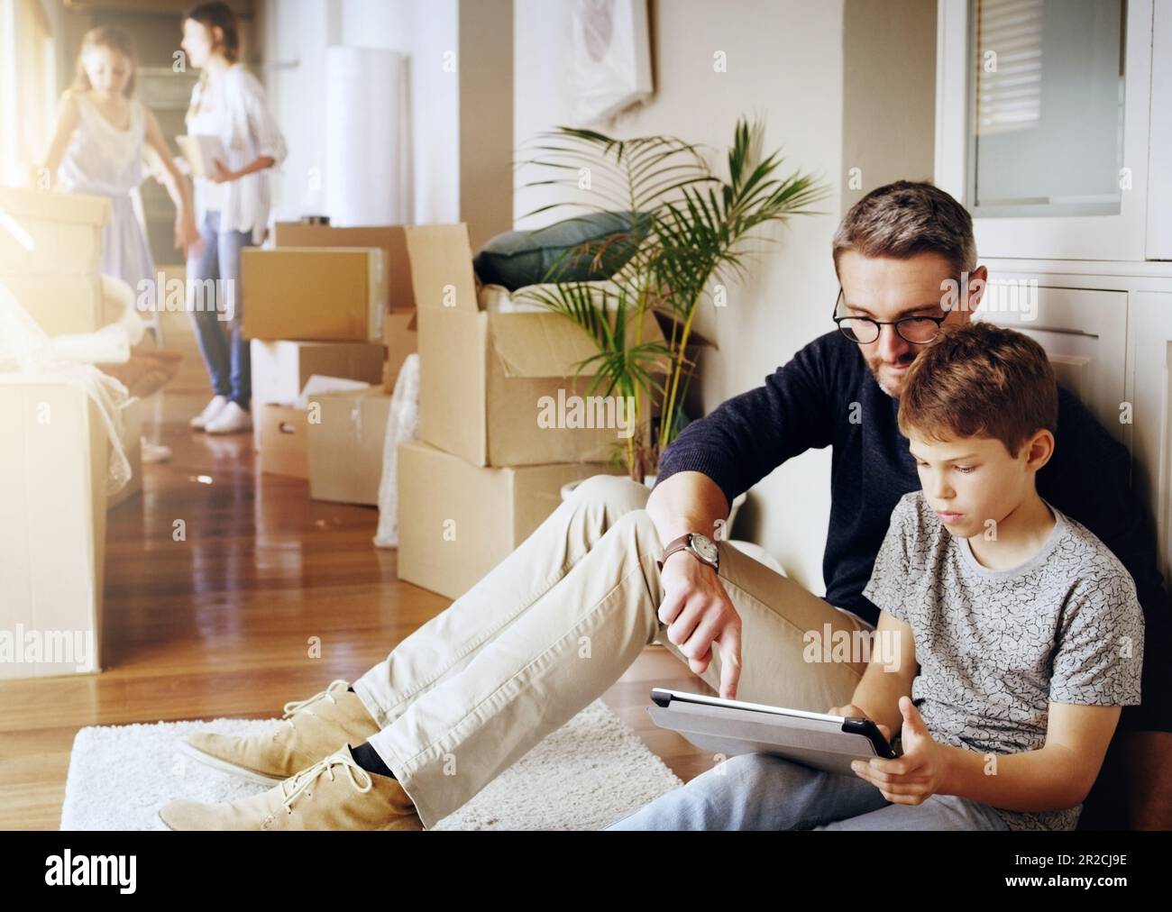 Man Boy And Tablet Playing Games And Relax Break From Unpacking And man-boy-and-tablet-playing-games-and-relax-break-from-unpacking-and