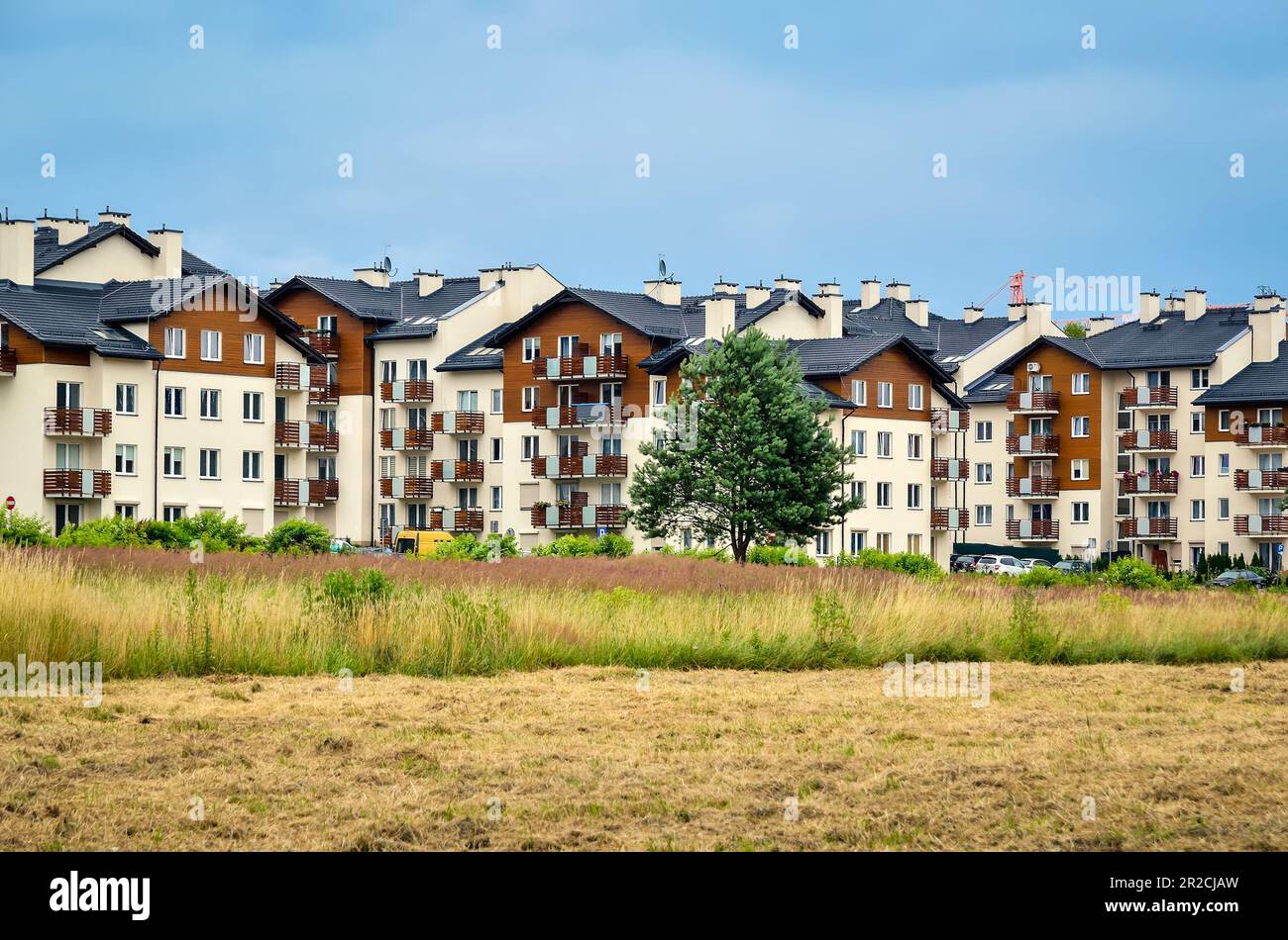 Tychy, Poland - July 14, 2015: New housing estates in Tychy City, Poland. Public view of newly built block of flats in the green area. Stock Photo