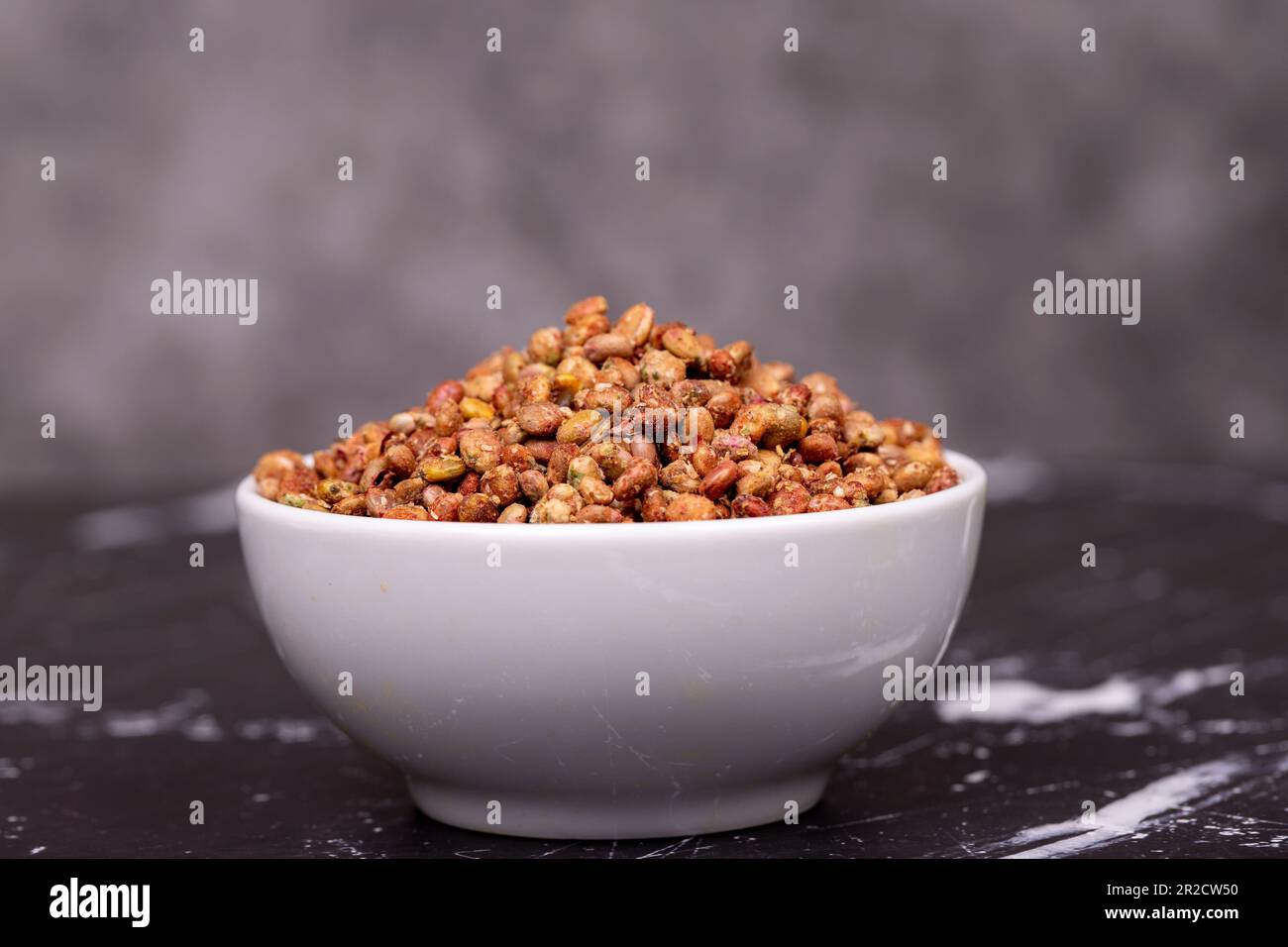 Sumac seeds. Dried sumac berries on dark background. Spice concept
