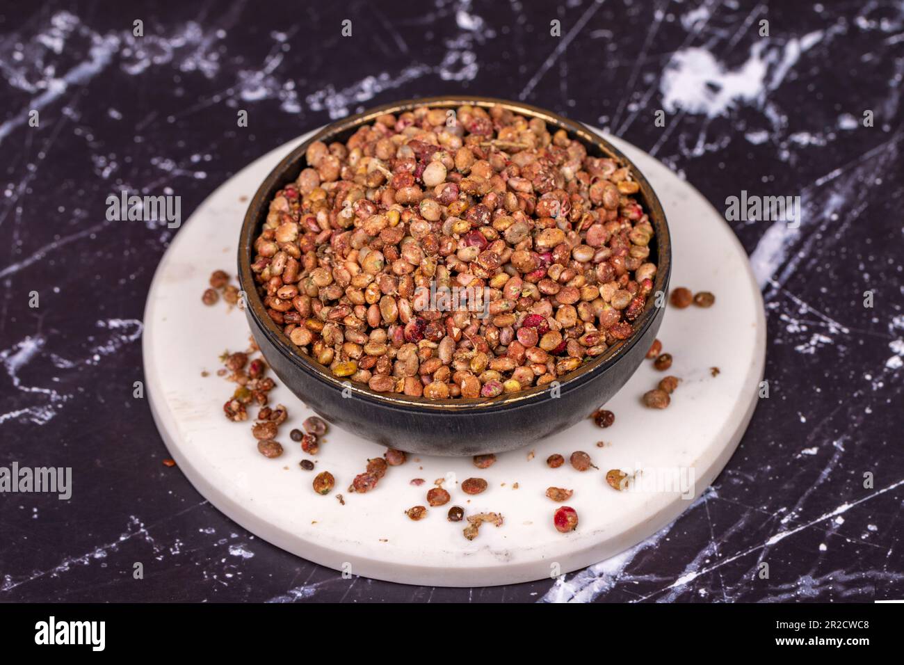 Sumac seeds. Dried sumac berries on dark background. Spice concept Stock Photo
