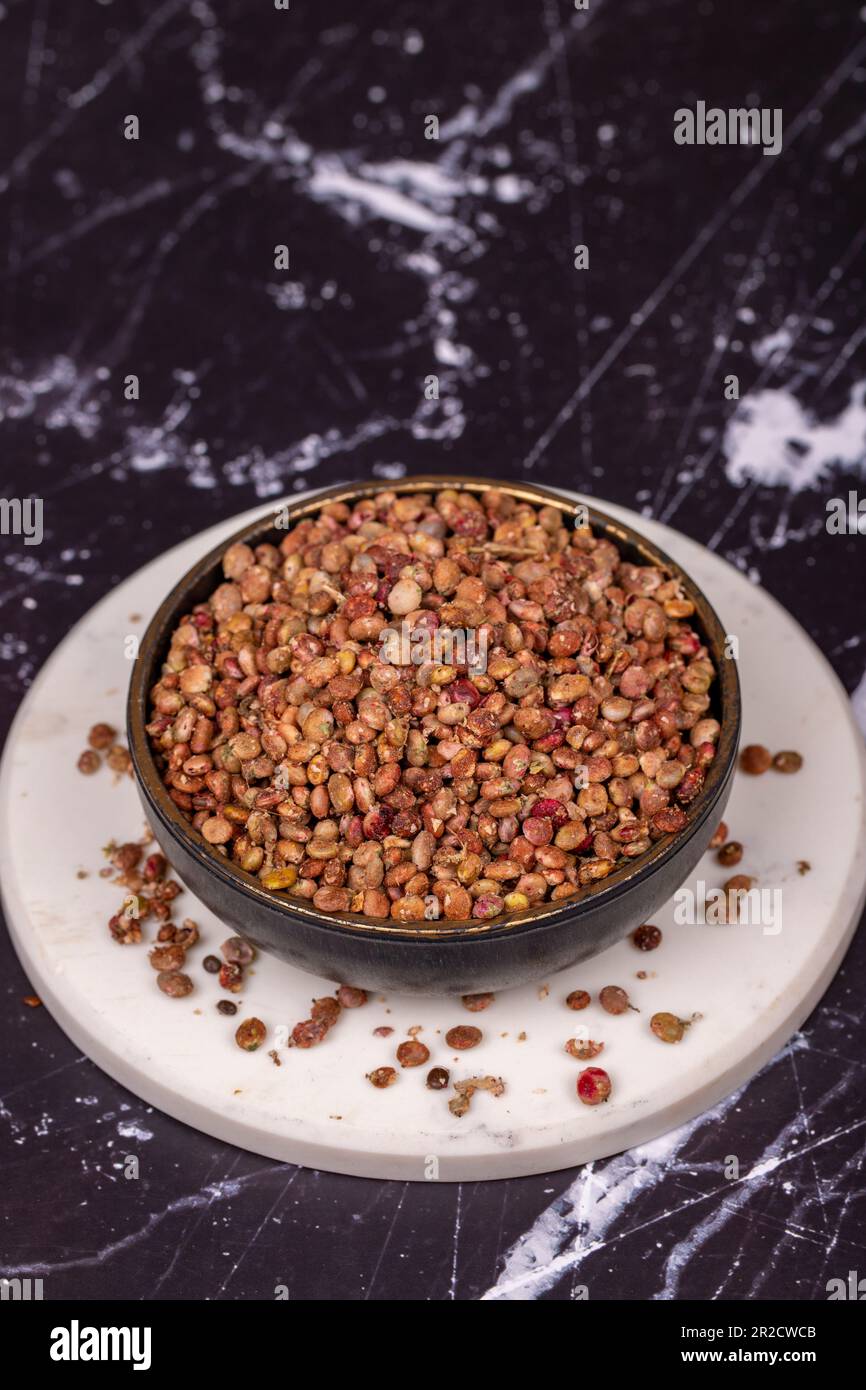 Sumac seeds. Dried sumac berries on dark background. Spice concept Stock Photo