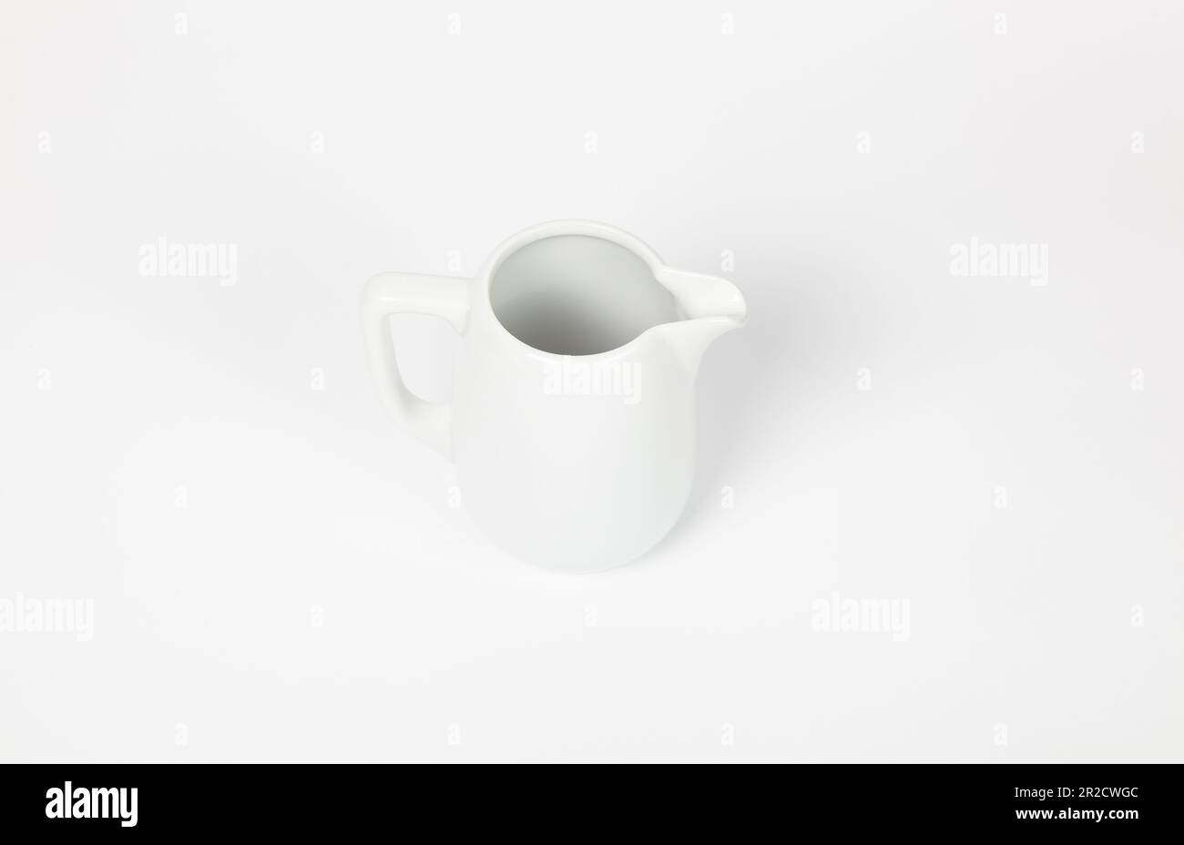 https://c8.alamy.com/comp/2R2CWGC/milk-jug-on-white-background-porcelain-sauce-boat-pitcher-creamer-or-ceramic-gravy-boat-space-for-text-for-advertising-banner-signboard-menu-a-2R2CWGC.jpg