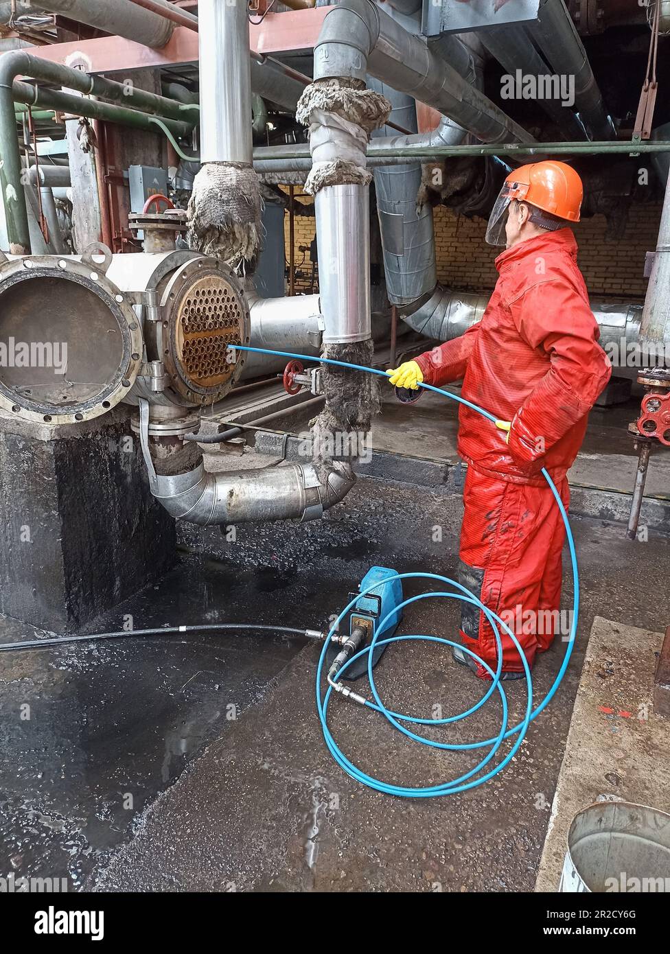 Man cleaning condenser tubes removing scales of petrochemical
