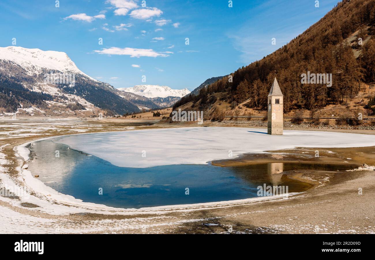 Famous 14th-century bell tower in Reschensee, Lake Reschen and the old submerged village of Graun. Reschen Pass, Vinschgau Valley, South Tyrol, Italy. Stock Photo