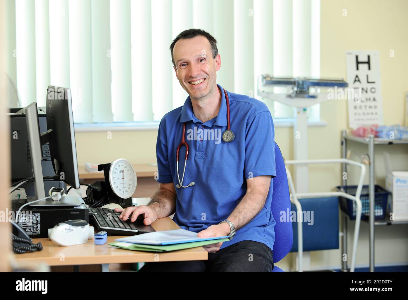 A NHS GP Doctor pictured in his general surgery. North Devon England UK ...