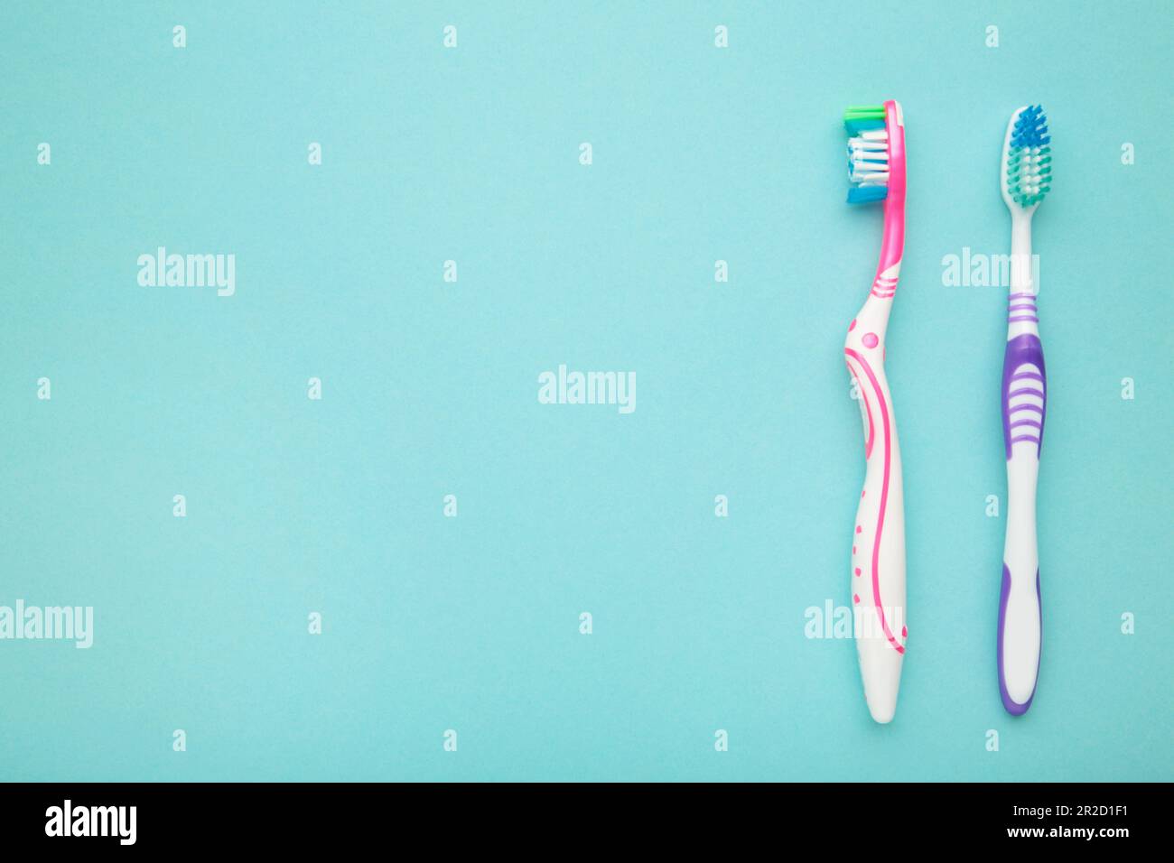 Two toothbrushes on blue background with copy space. Top view Stock ...