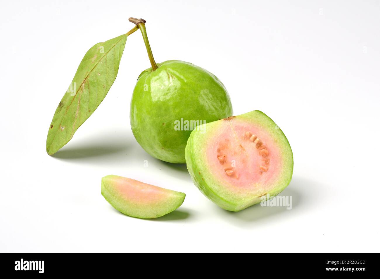 Pink guava fruits isolated on white background.Guava fruit with leaf isolated on white background.Thai Pink guava fruits isolated on white background. Stock Photo