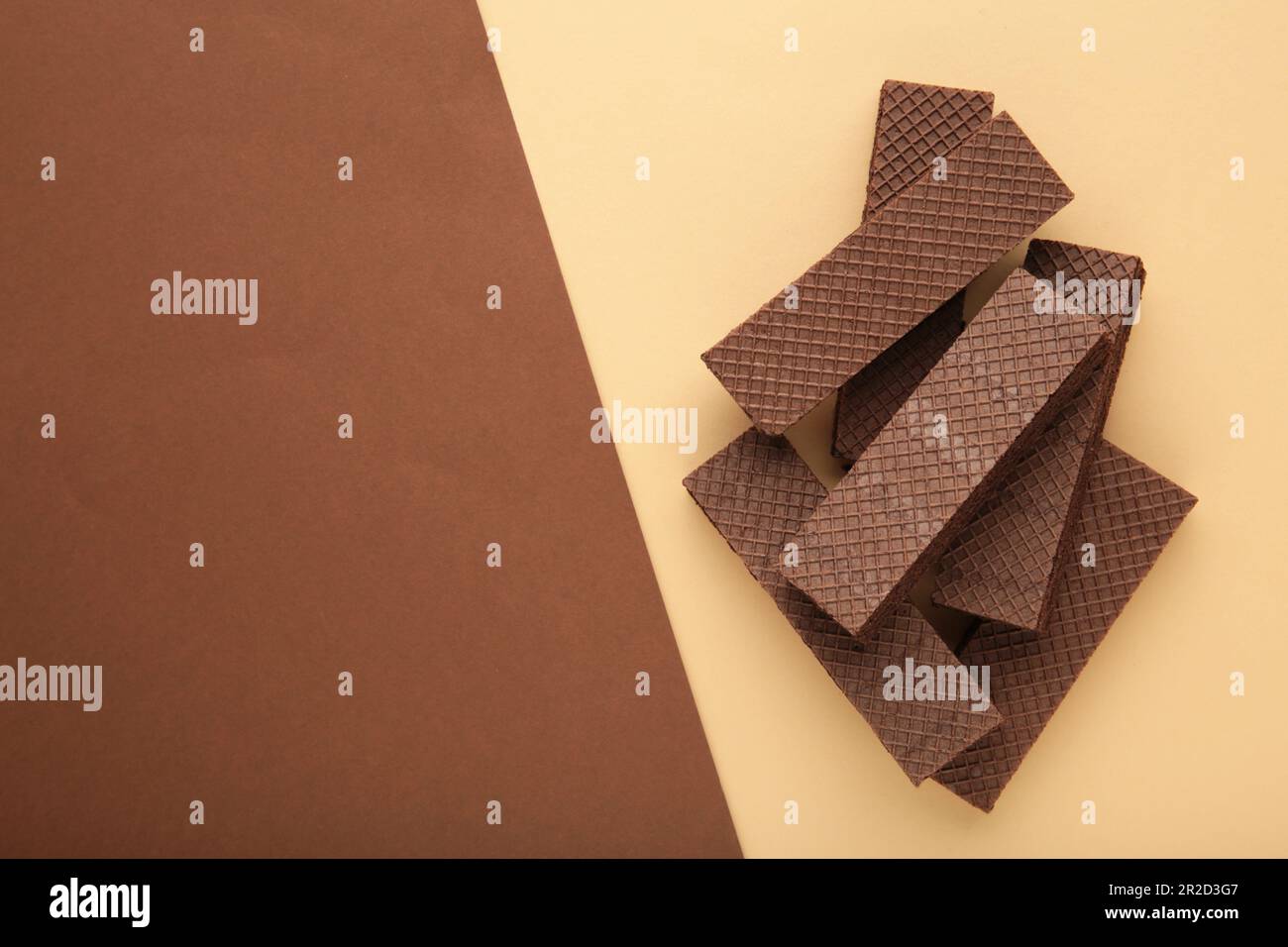 Chocolate wafers with coffee on beigeand brown background. Top view Stock Photo