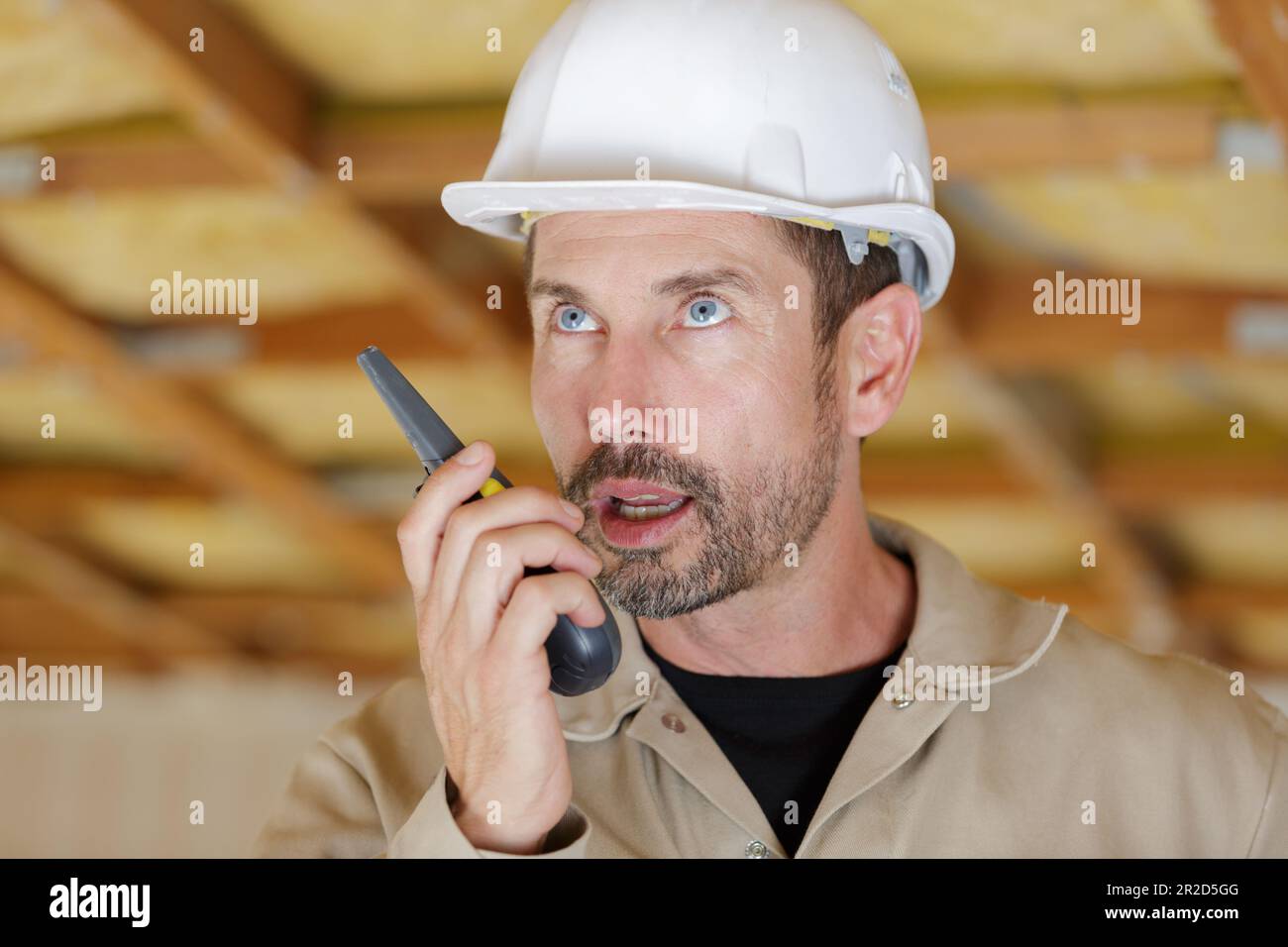 male builder in hardhat with walkie talkie Stock Photo