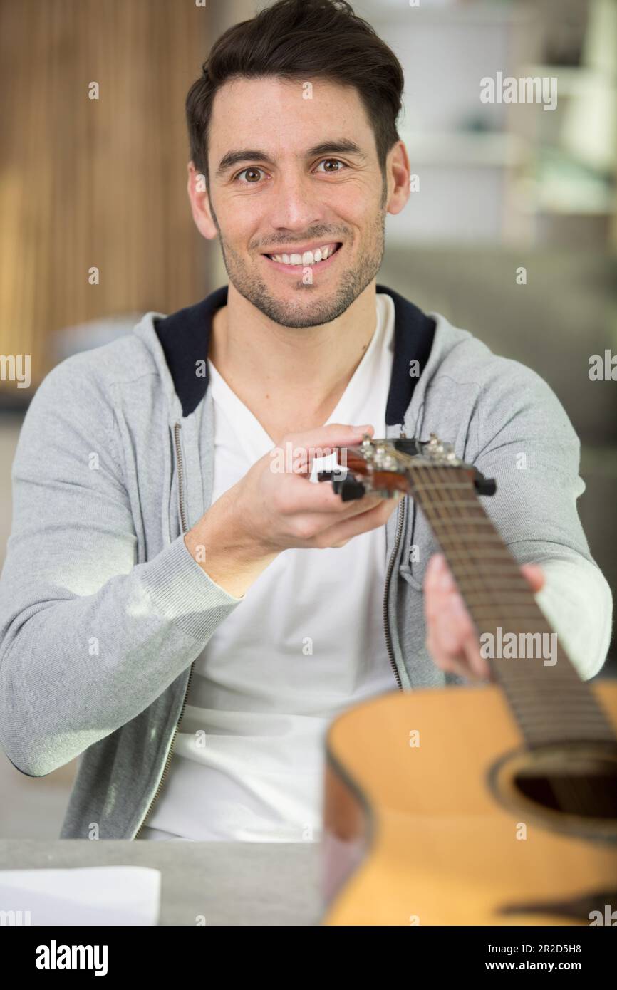 man playing the guitar at home Stock Photo - Alamy