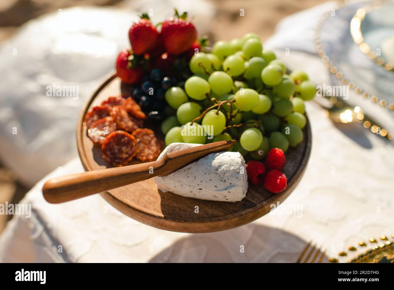 Appetizer or Charcuterie board with assorted fruit, meat & goat cheese