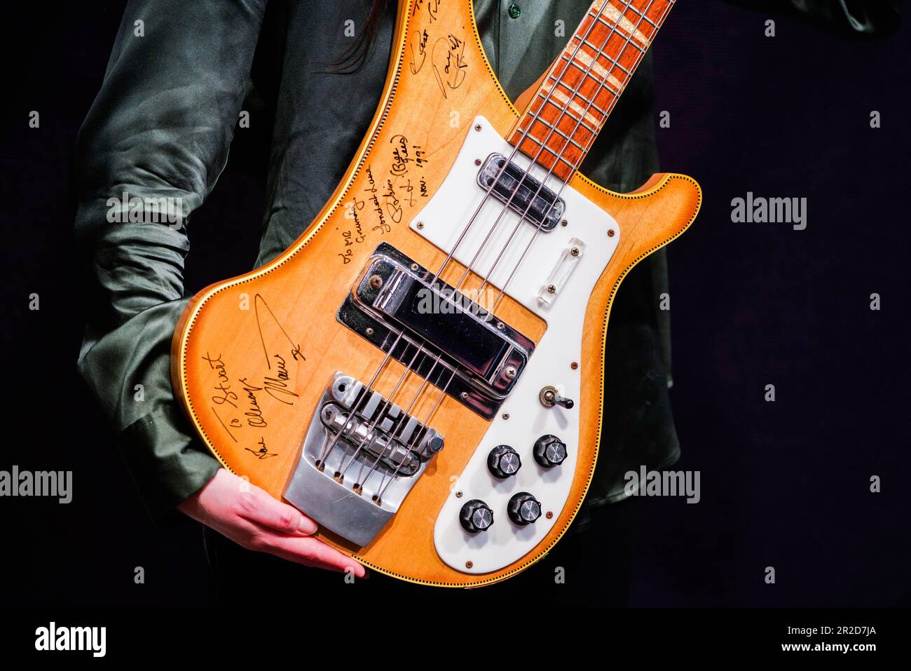 London UK. 19 May 2023  . A Bonhams art handler holds a Bee Gees / Maurice Gibb: A Rickenbacker 4001 Bass Guitar, Signed By Each Member Of The Bee Gees, Estimate £10,000 - £15,000. Press photocall  from the Rock, Pop & Film sale at Bonhams Knightsbridge. The sale takes place on 24 May Credit: amer ghazzal/Alamy Live News Stock Photo