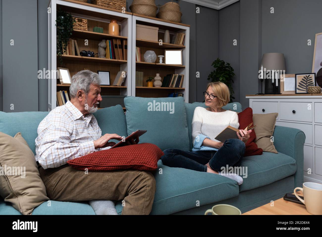 Happy senior married couple relaxing together at home with the wife ...