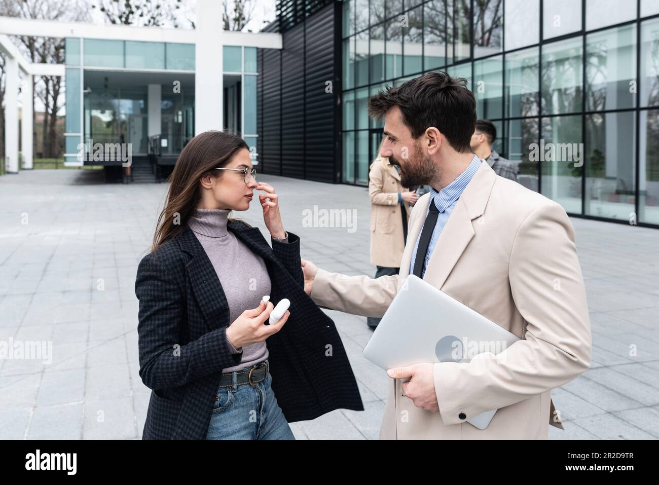 Business team colleagues partners standing in front of office building discussing ideas and concepts of cooperation gossiping other employees of compa Stock Photo