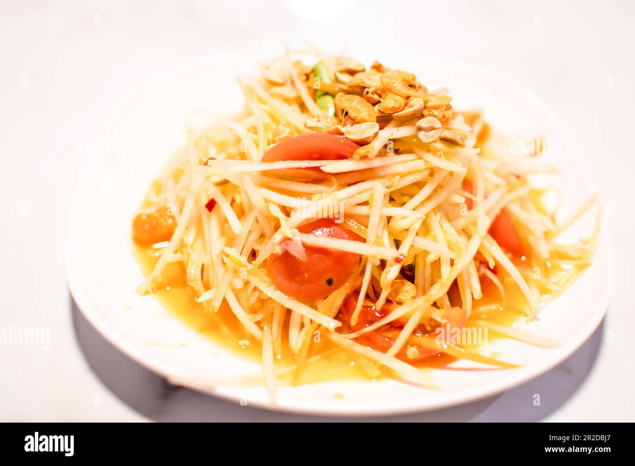 The papaya salad has pepper, dried shrimp, and tomato is the Thailand