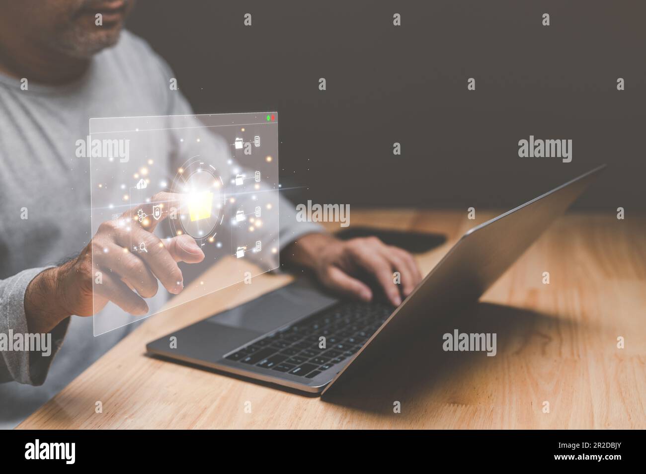 Businessman working from home using laptop with virtual screen. Process data and manage files on Internet efficiently. Online document database system Stock Photo