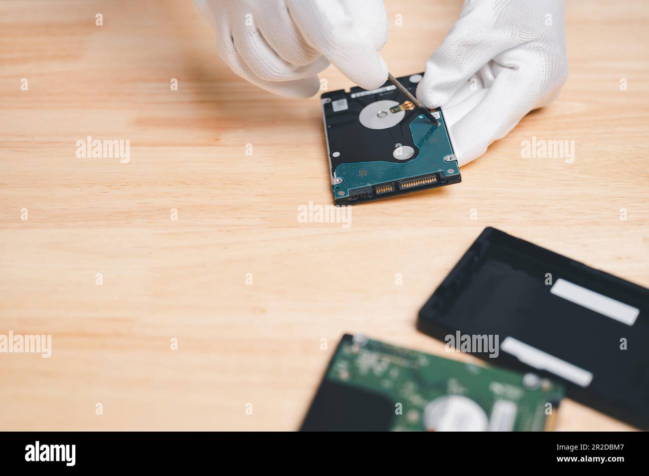 fix and repair hard drive computer for recovery data and backup to storage new concept. hand of engineer holding hard drive or disk for repair, fix Ba Stock Photo