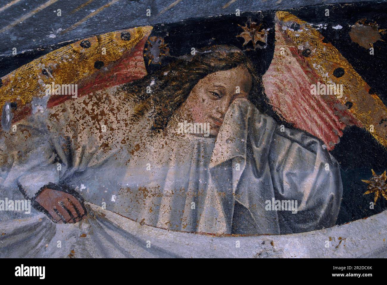 Weeping angel with golden wings and gold-flecked hair. Renaissance fresco in the Cathédrale St-Lazare d’Autun (Cathedral of Saint Lazarus of Autun), founded circa 1120 AD at Autun, Saône-et-Loire, Bourgogne-Franche-Comté, France. Stock Photo