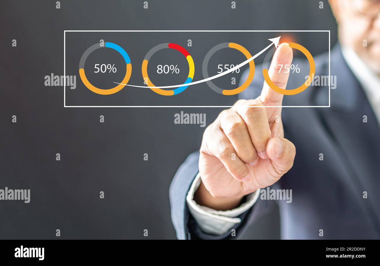Businessman wearing a black suit pointing high graph to tell interest ...
