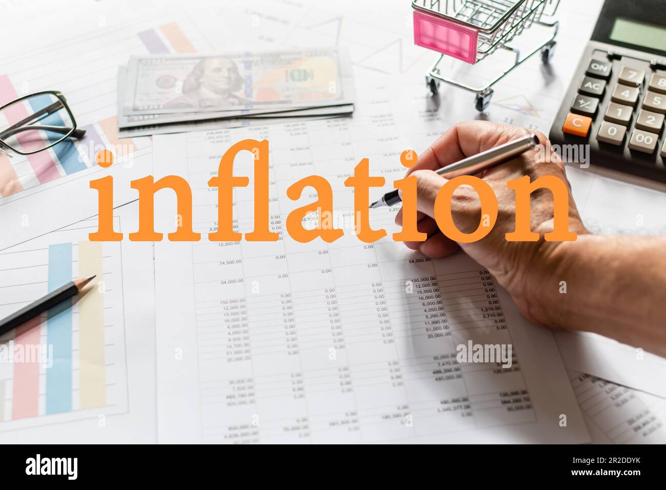 A businessman holding a pen and checking numbers in severe inflation