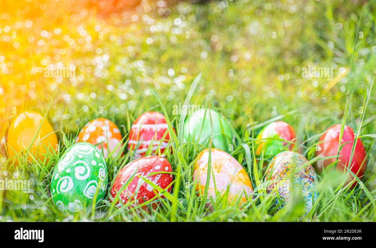Abstract Defocused Easter, Closeup, many beautiful painted eggs as grass blurred background. concept for good friday, easter monday. copy space on top Stock Photo