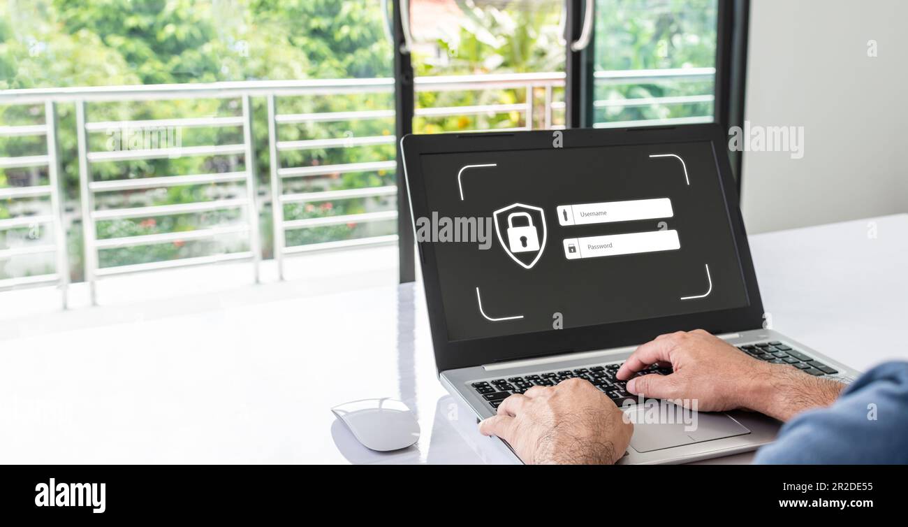 Man typing username and password with a laptop to log into the system. Concept of using technology to work in various fields of finance, banking,  net Stock Photo