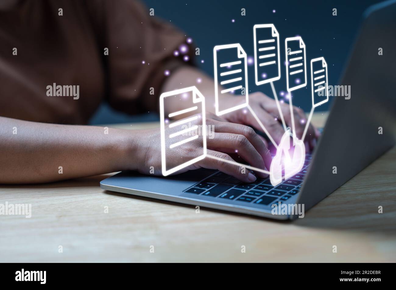 Businessman using laptop with virtual screen to backup data. Process data and manage files on cloud server efficiently. Online document database syste Stock Photo