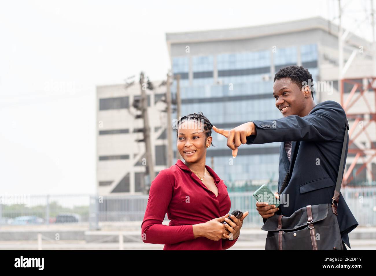 african man giving a lady directions Stock Photo