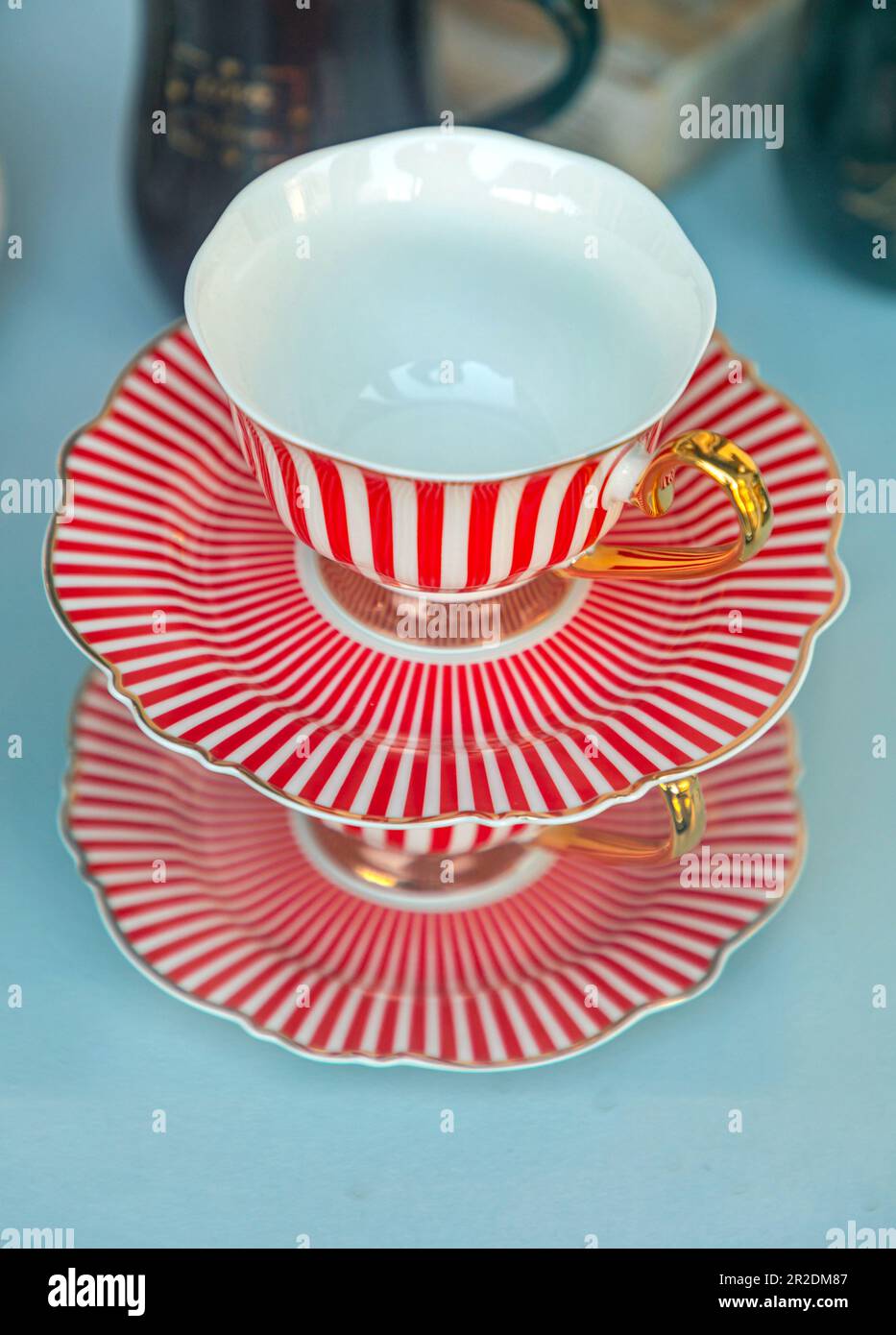 Red and White Porcelain Tea Cup With Gold Handle Stock Photo Alamy