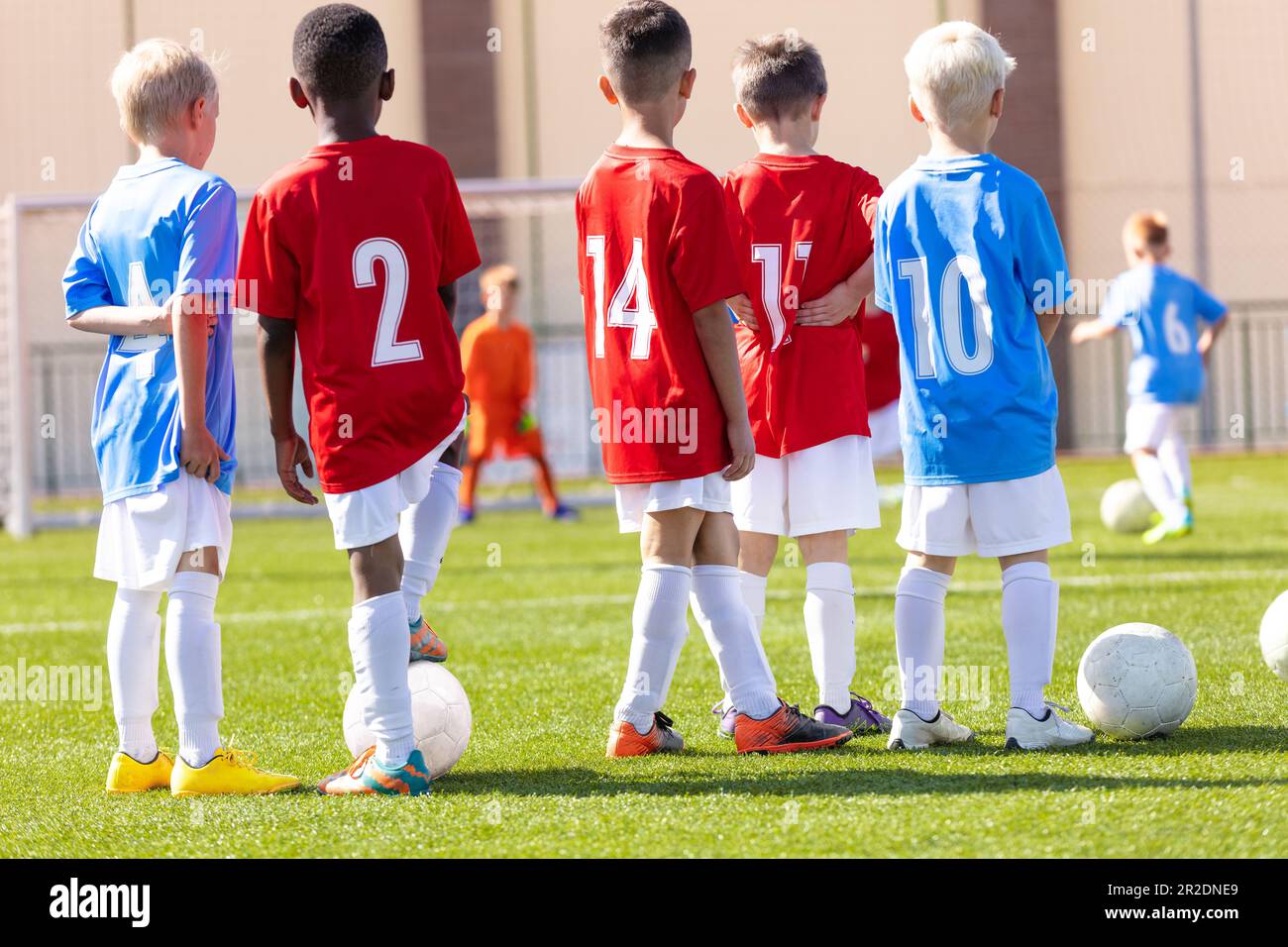 Youth soccer football team. Soccer team practicing penalty kick. Group photo. Soccer players standing together at training. Teammates at soccer traini Stock Photo