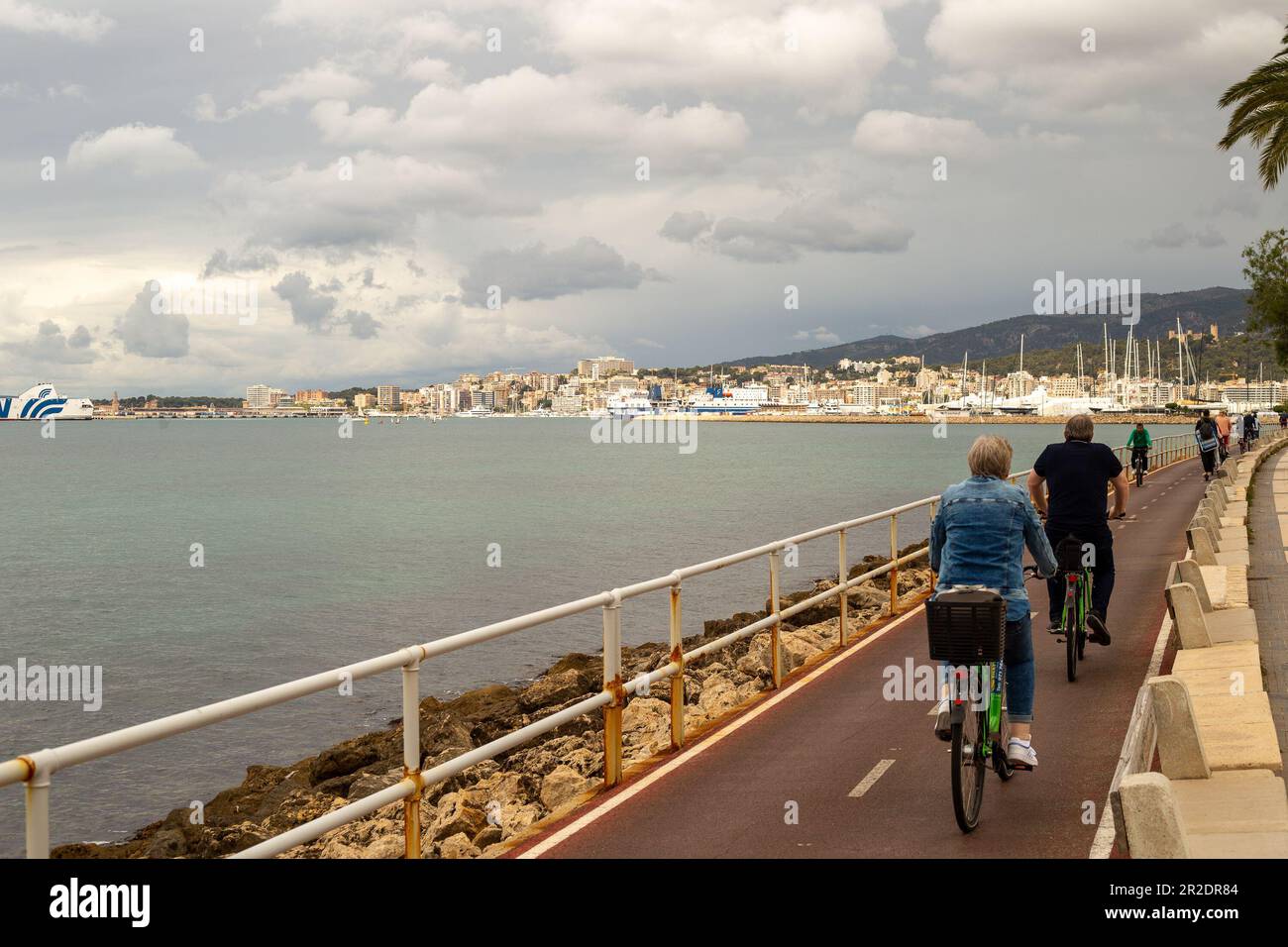 Palma de Majorca, Spain - May 13th 2023: Cyclists on the cycle path along the coast to Palma town Stock Photo