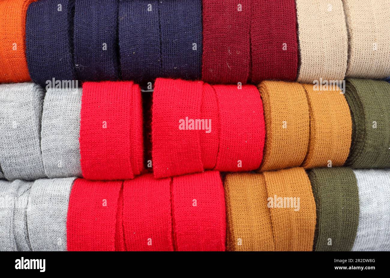 Samples of cloth and fabrics in different colors found at a fabrics market. Stock Photo