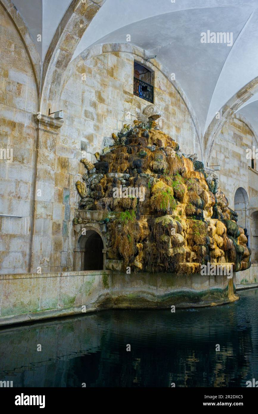 The mineral and weed encrusted water entry point from the aqueduct at the museum of water, Lisbon Stock Photo