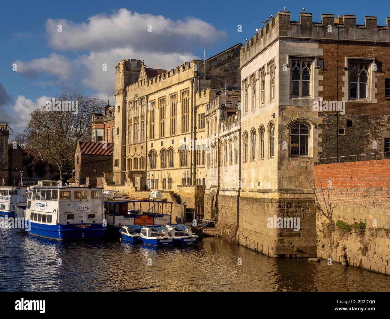 Moored tourist cruise boats on the river Ouse alongside the Guildhall. York. UK. Stock Photo