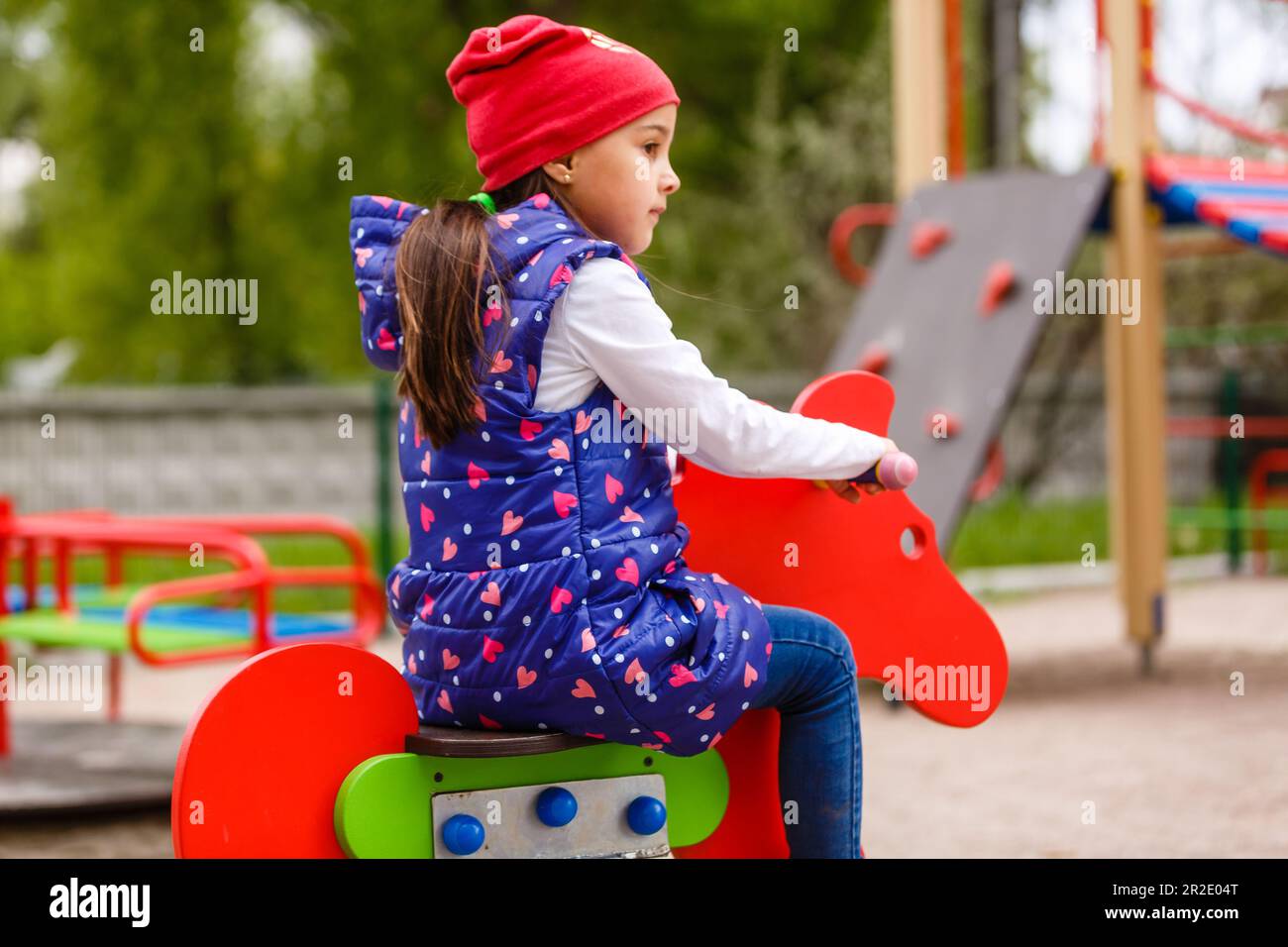 Active little girl playing on a playground Stock Photo - Alamy