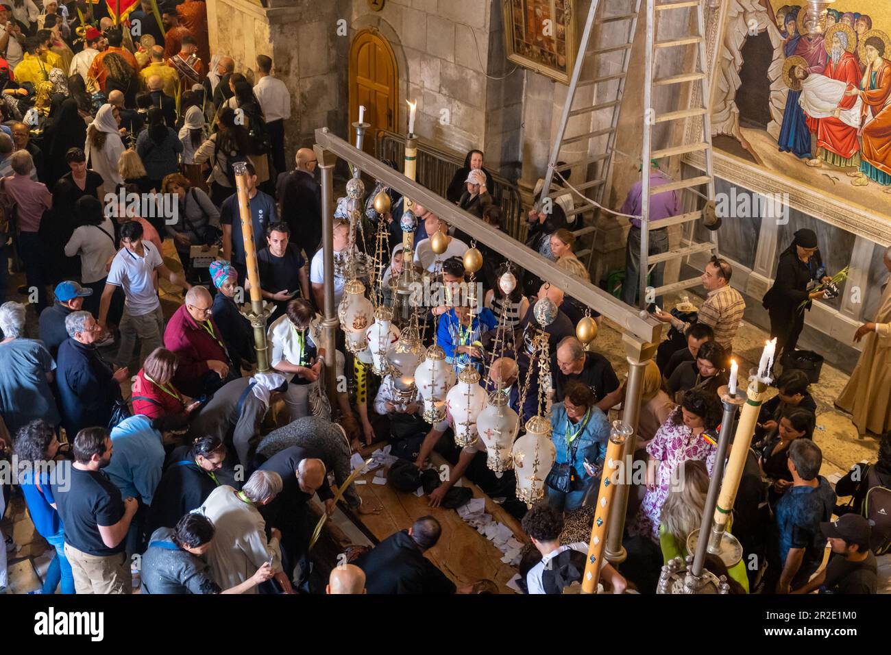 Jerusalem, Israel - 10 April, 2023. Tourists and pilgrims at the Stone of Anointing in the church of holy sepulchre Stock Photo