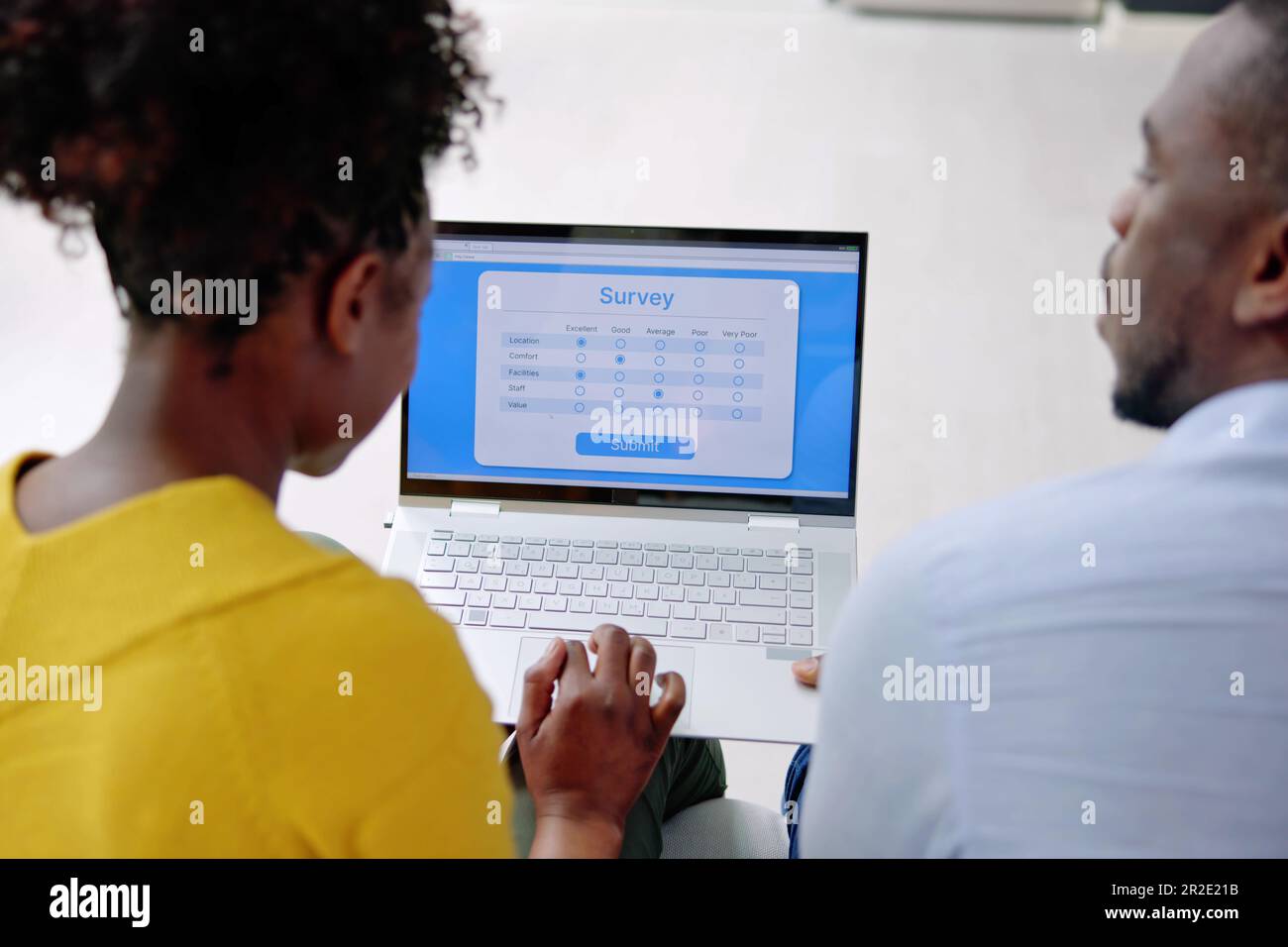 African Man Filling Survey Poll Or Form On Laptop Computer Stock Photo ...