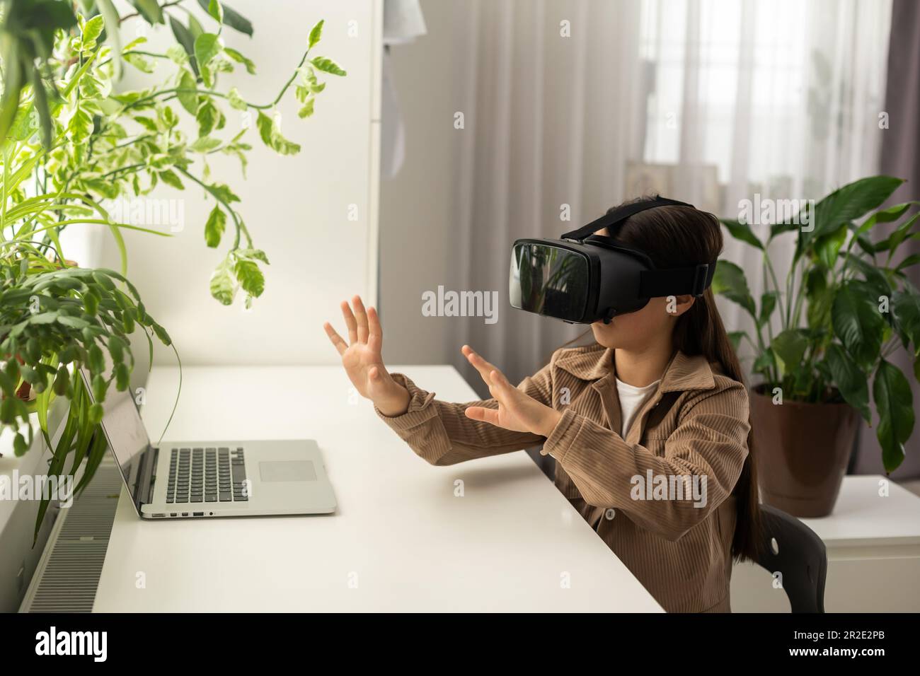 Virtual classes. Driving lessons. Science Class. VR technology. schoolgirl using virtual reality helmet. Virtual reality headset. Teenager student Stock Photo