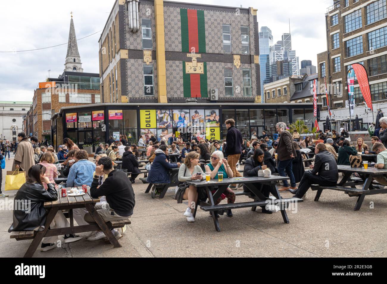 LONDON, ENGLAND - April 12, 2023: a motley crowd of East London drinking a beer outside of pub. Stock Photo