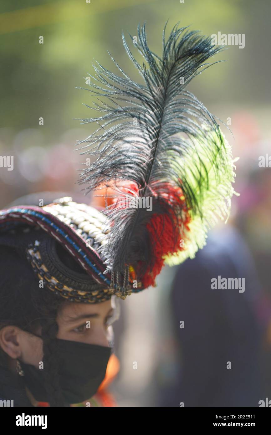Bamburet, KPK,Pakistan - 05152023: A feather on the headgear of a Kalash woman at the Chilam Joshi Festival Stock Photo