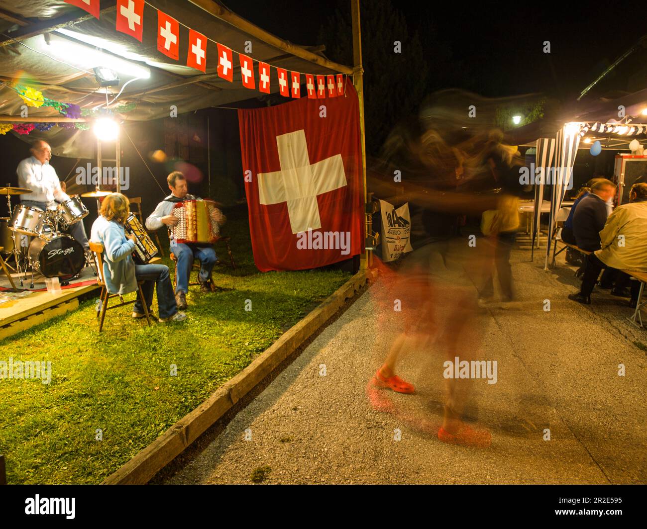 people dance to live music at a summer fete in switzerland Stock Photo